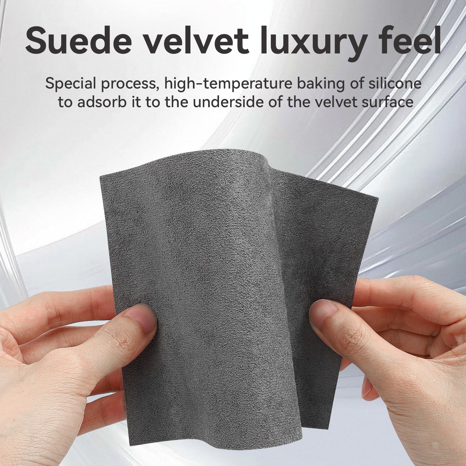 Close-up of hands holding a flexible grey suede velvet material, highlighting its soft texture and luxury feel, with text explaining the special high-temperature silicone baking process on the underside for adsorption.