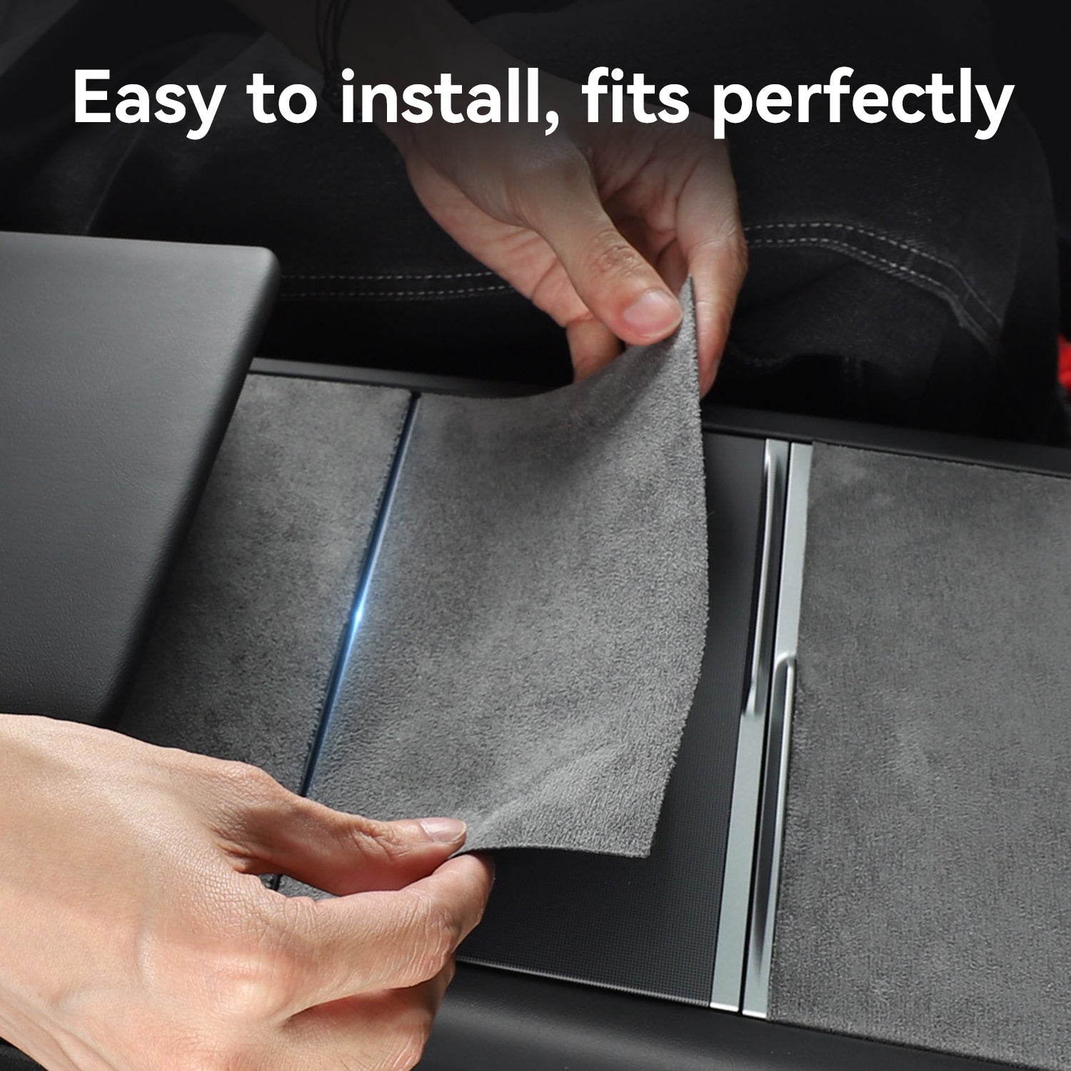 Hands installing a grey suede center console wrap on a Tesla, demonstrating how the custom-fit protector is easy to apply and fits perfectly over the original surface.