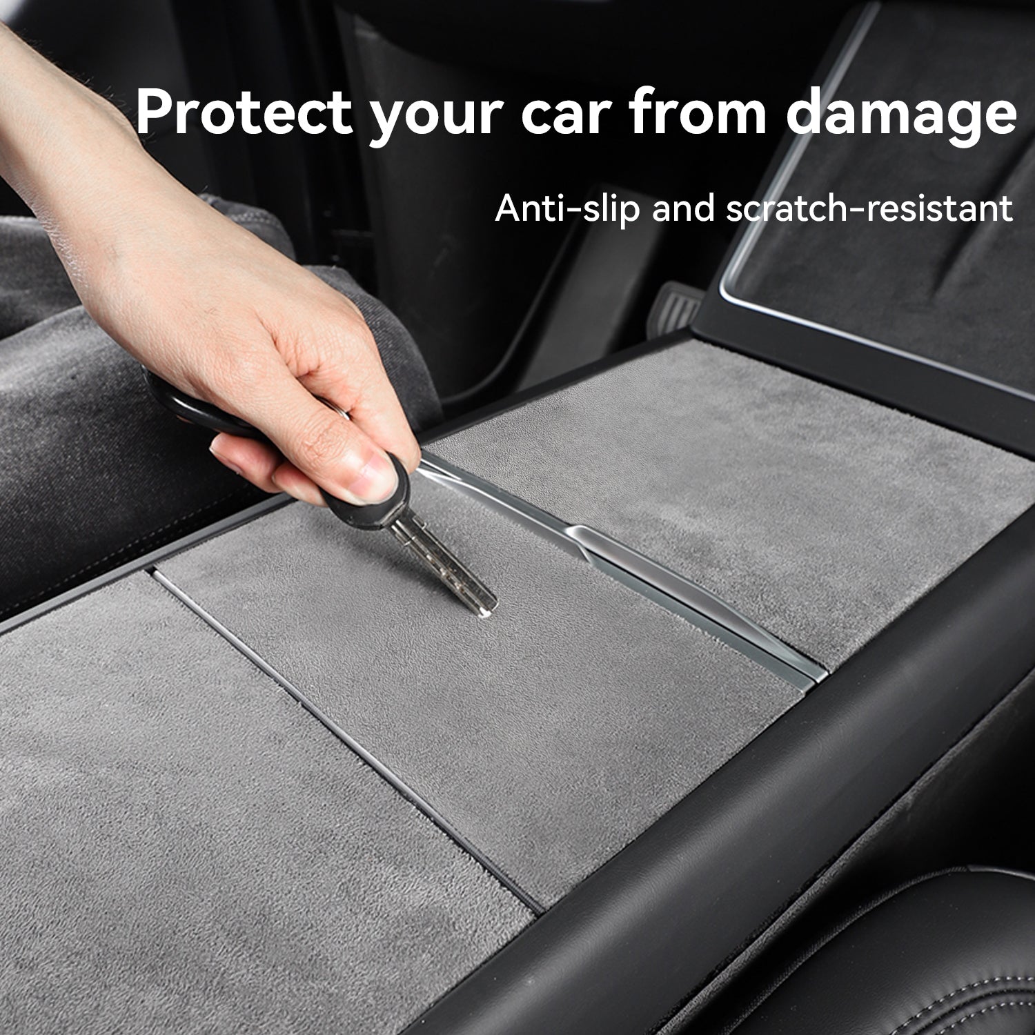 Demonstration of a scratch-resistant suede center console wrap on a Tesla, with a hand using a metal key to scrape the surface, proving its durability and ability to protect the car interior from damage.